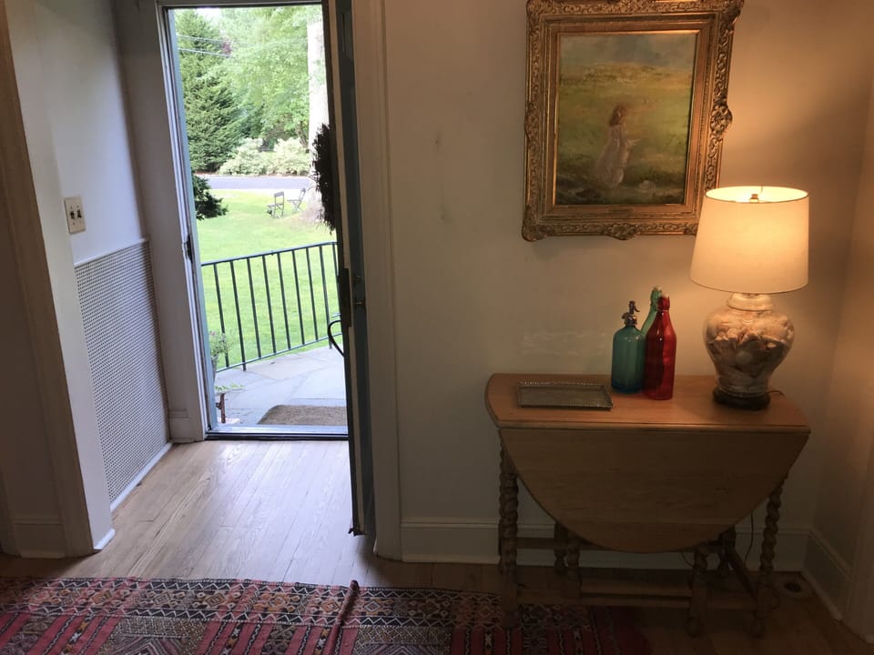 Main door entrance with antique gateleg table and artwork 