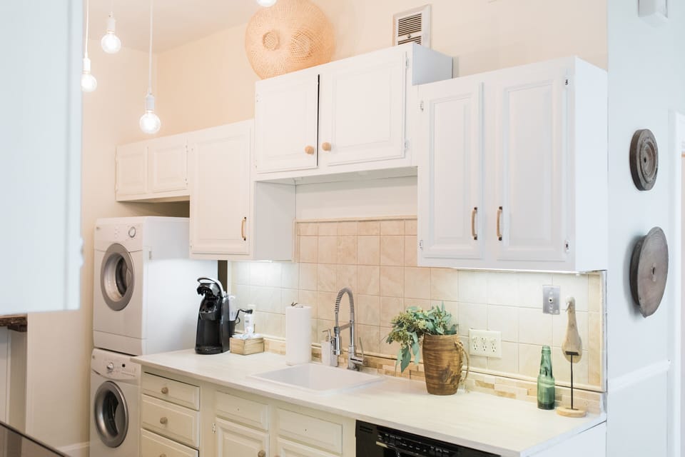 The kitchen includes a washer and dryer