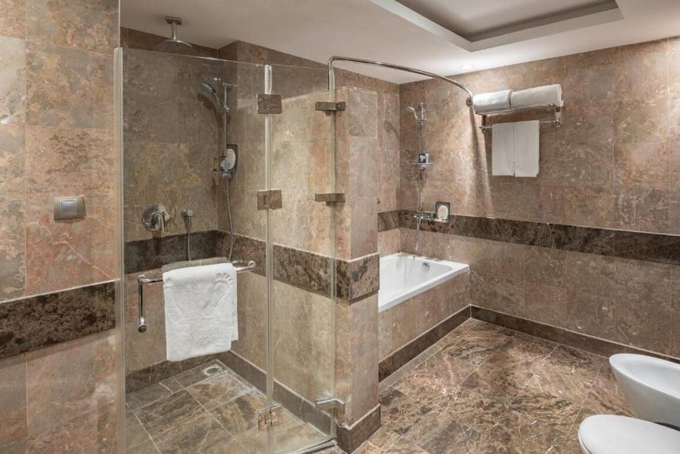 Junior Suite, 1 King Bed | Bathroom | Bathrobes, slippers, towels