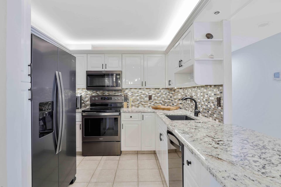 Condo, Multiple Beds (Alluring beachfront condo with pool a) | Private kitchen | Fridge, microwave, oven, stovetop