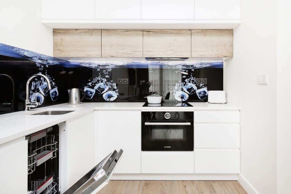 Another view of the modern kitchen with white cabinets and a clean design, showing a well-organized layout.