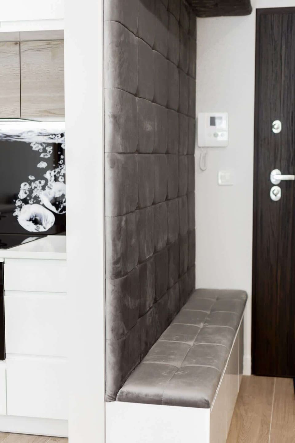 A minimalist hallway with dark-colored doors and a clean, simple design.