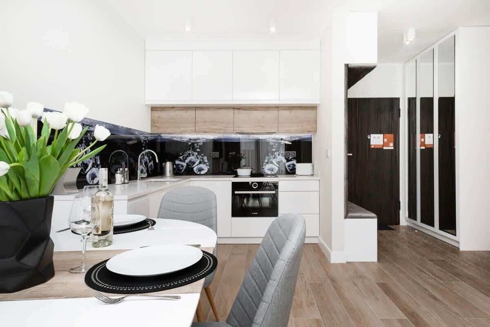 A dining area with contemporary furniture and tableware, making the space look ready for a meal.