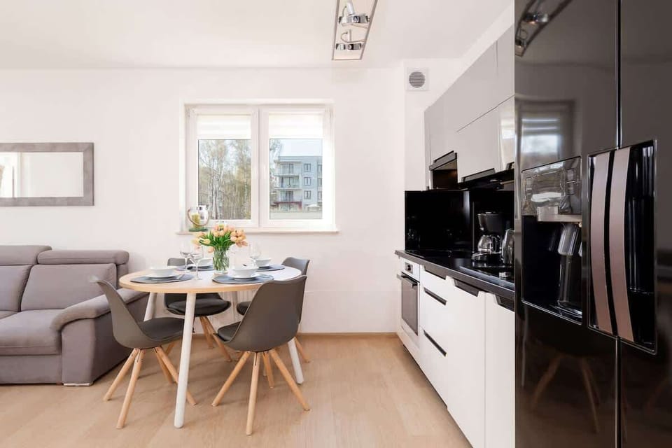 A combined living room and kitchen area with modern furnishings and decor.