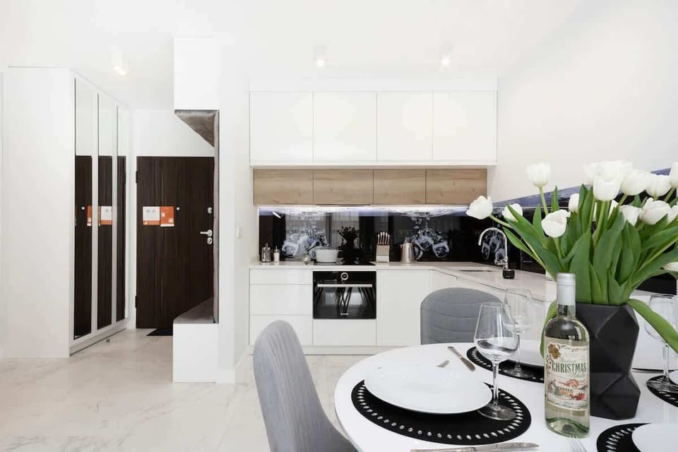 A dining area with contemporary furniture and tableware, making the space look ready for a meal.