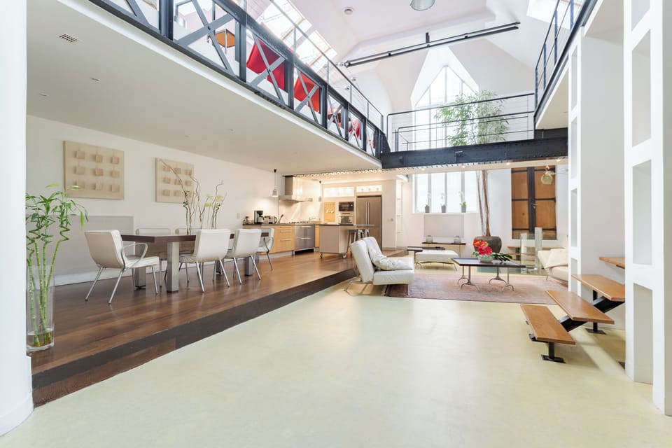 Living room with 7m high ceilings, cathedral window and floating passageways
