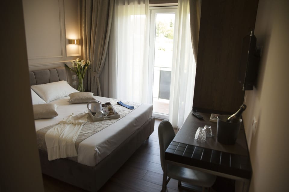 Deluxe Double Room, Balcony | Minibar, in-room safe, desk, laptop workspace