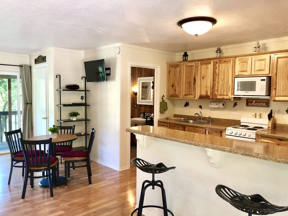 Kitchen and dining area with old fashioned tractor bar stools 