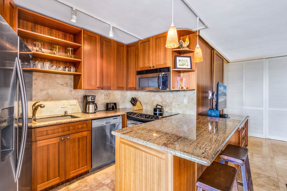Full kitchen w/ custom cabinetry, all stainless steel appliances & granite. 