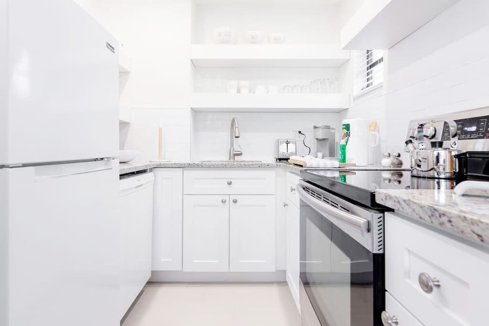 Fully stocked kitchen complete with  cooking utensils .