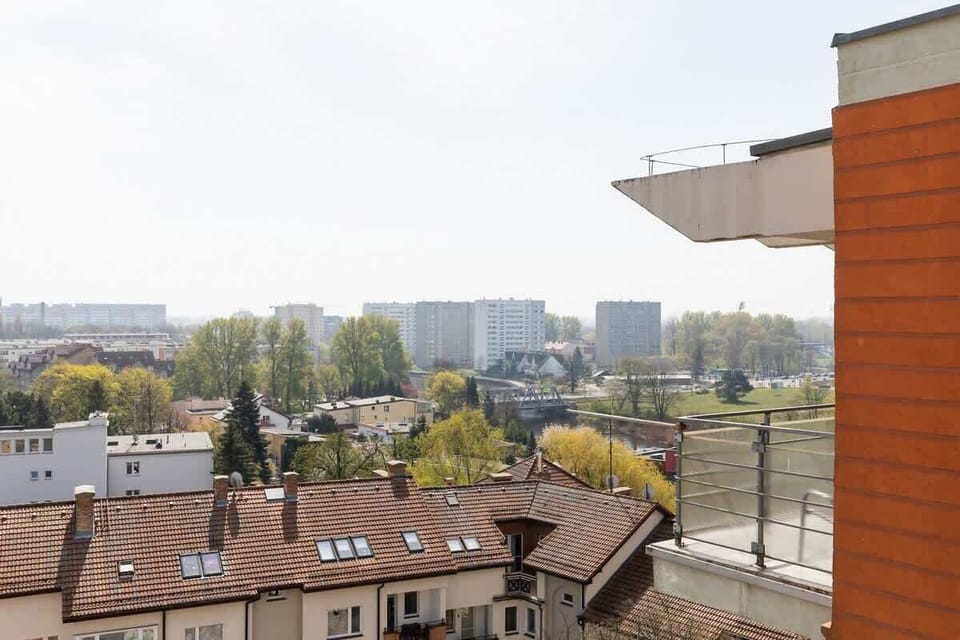 A view of the surrounding area from an elevated perspective, showing nearby buildings and greenery.