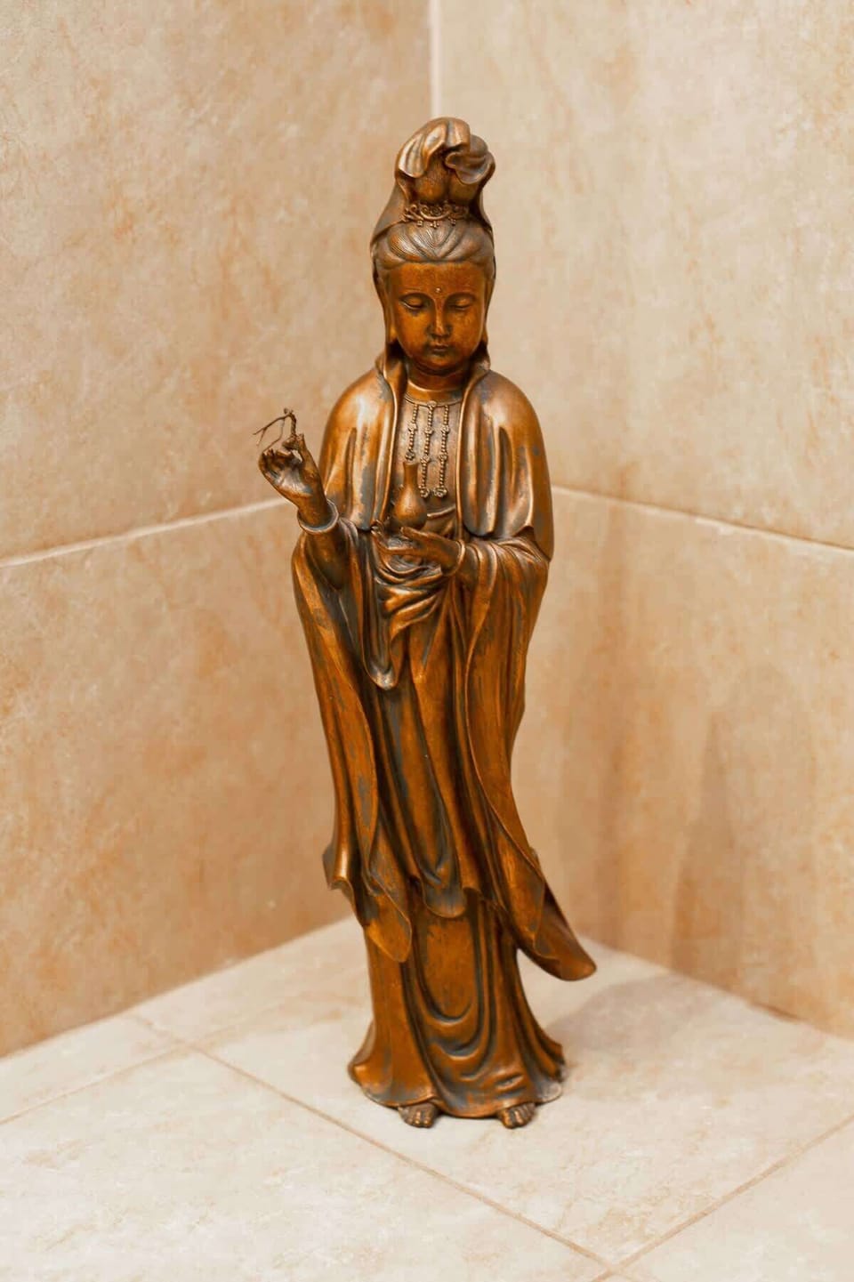 A unique decorative statue in the bedroom, adding personality to the space.