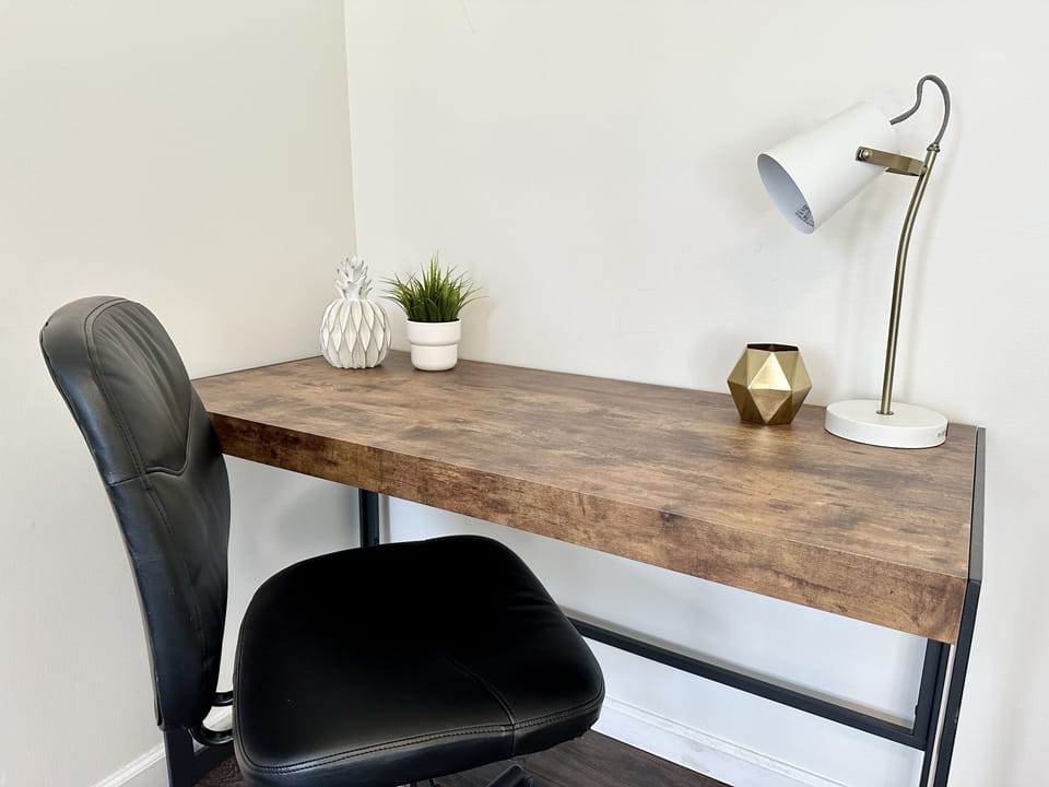 Large office desk with comfy chair.