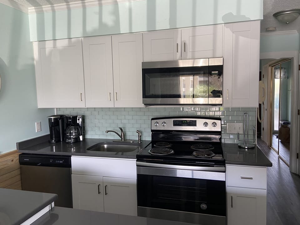 Quartz counter tops and both a Mr Coffee and Keurig coffee maker provided.