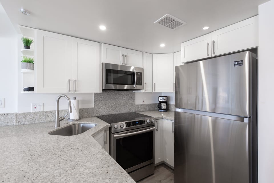 Fully stocked kitchen boasting modern stainless-steel appliances