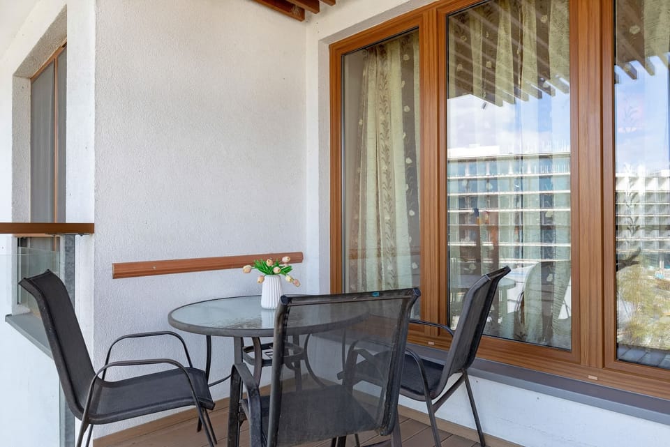 A private balcony with a small table and chairs, an ideal spot for enjoying coffee or relaxing outdoors.