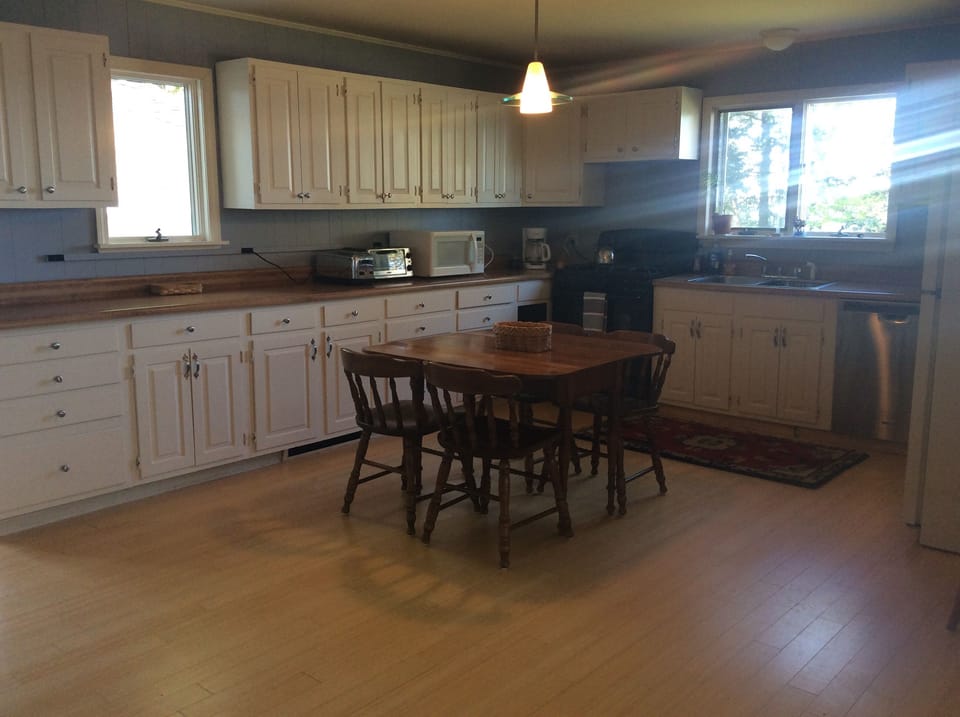 Large farm-style kitchen with ocean views