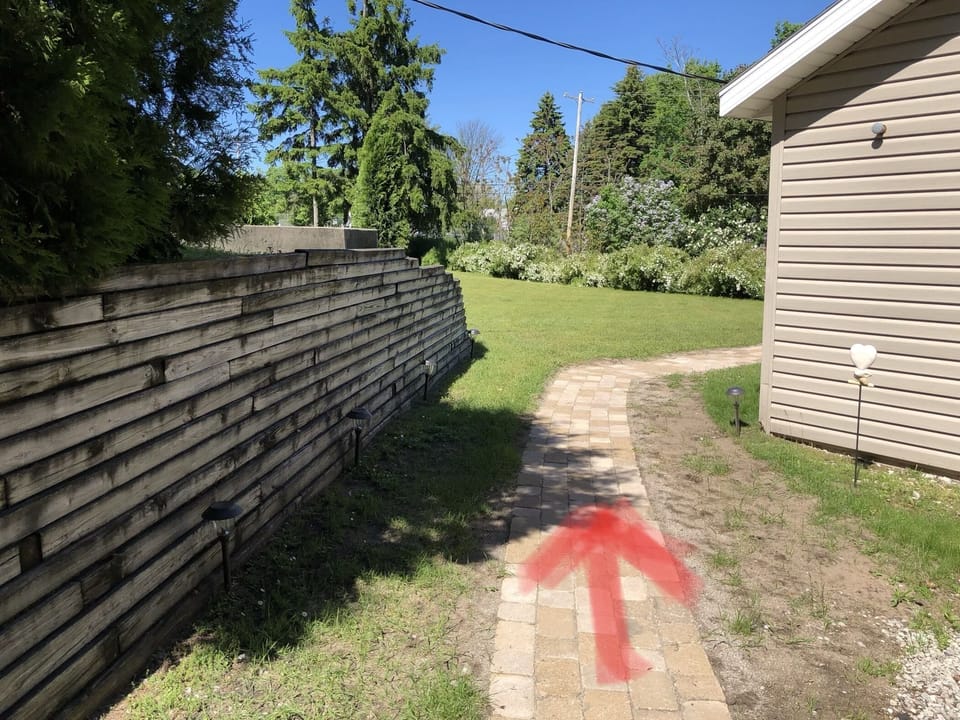 Follow the path around the detached garage.