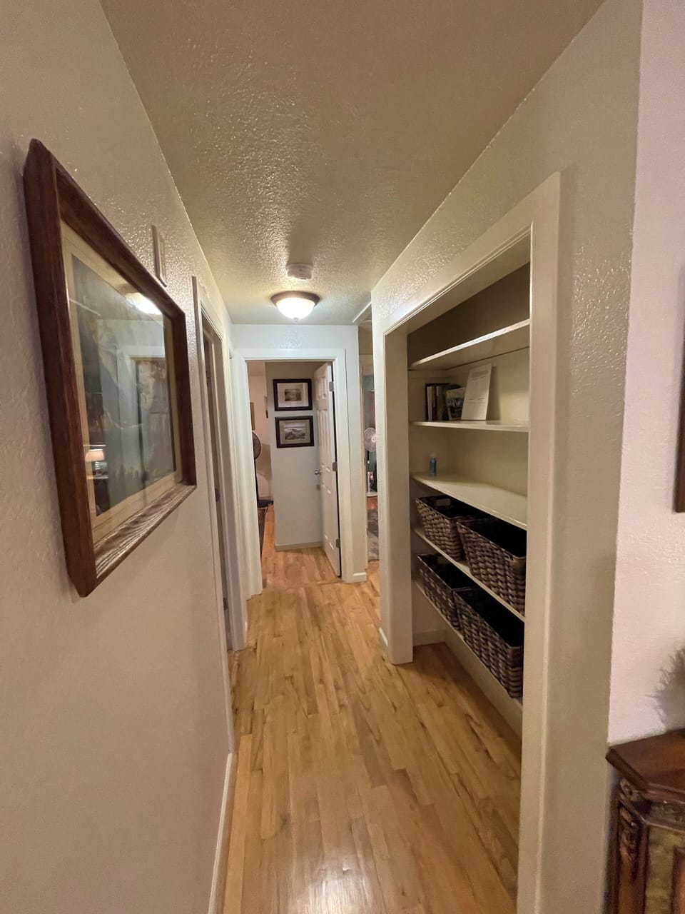 Hallway to the bathroom and three bedrooms