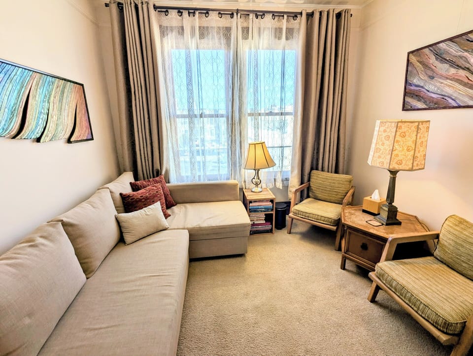 Room 1 can be set up as a living room or queen bedroom. It has 2 large windows.
