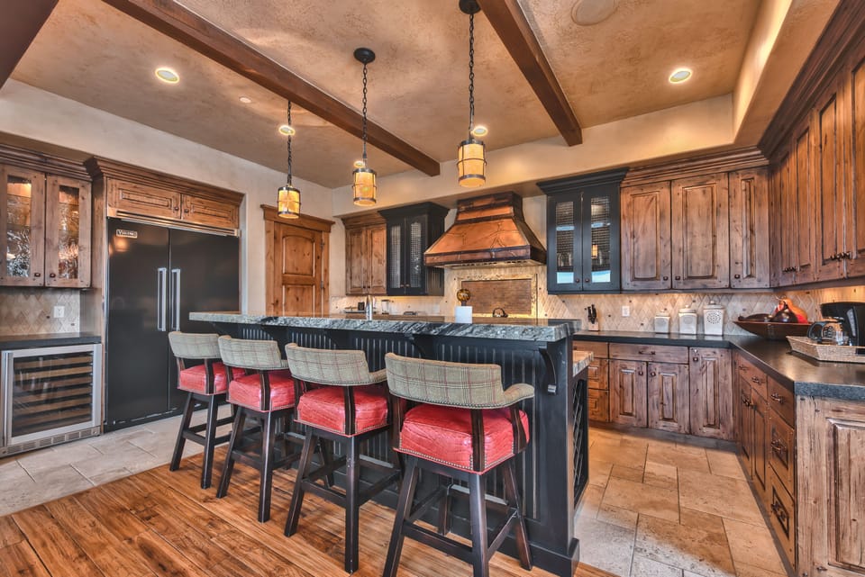 Chefs Kitchen with Stunning Cabinetry, Granite Counters, and Island/Bar with Seating for 4