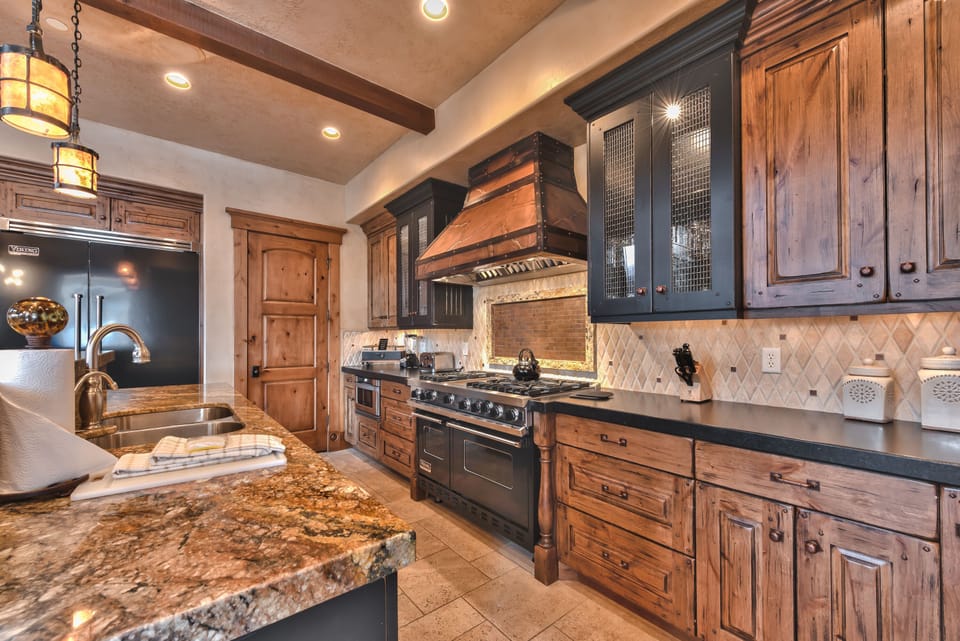 Fully Equipped Gourmet Kitchen with Viking 6 Burner Gas Range with Double Ovens, a Viking Refrigerator and Wine Fridge, and Plenty of Counter Space for Meal Prep or Entertaining