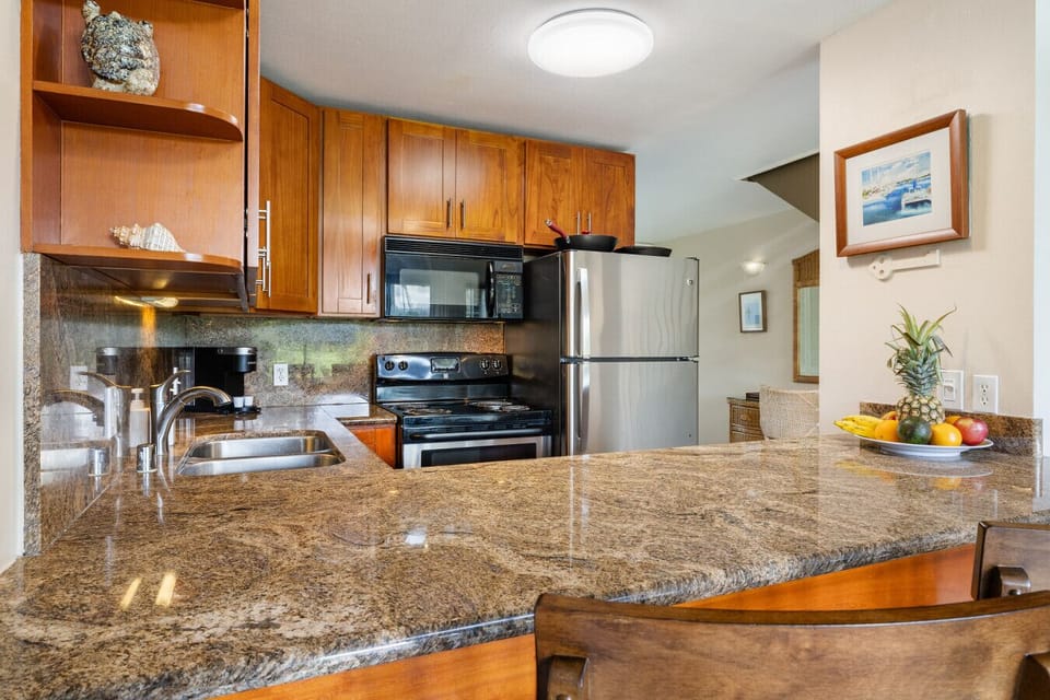 Spacious kitchen w/ granite counters & stainless appliances for easy cooking.