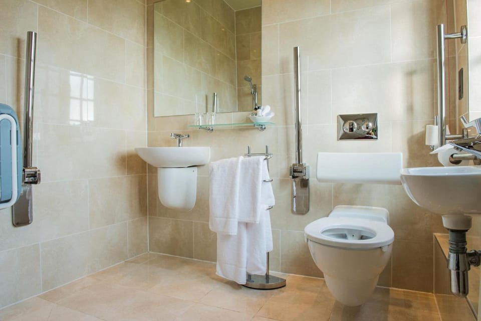 Shower, designer toiletries, hair dryer, towels