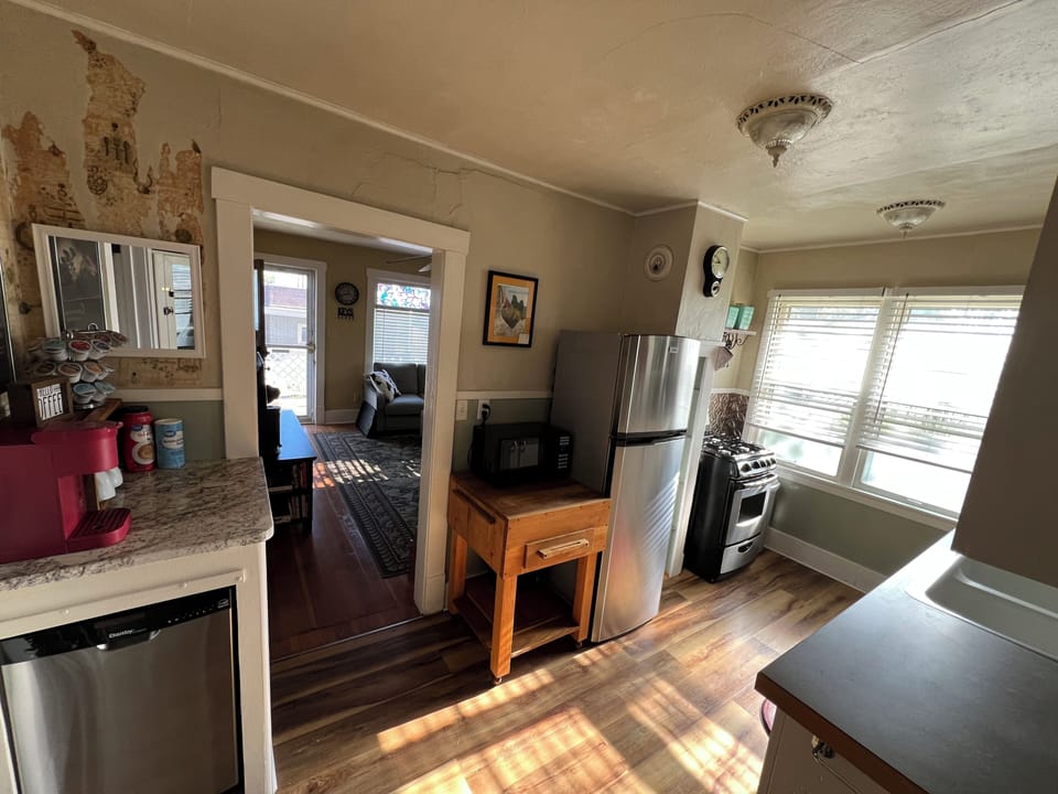Full kitchen with microwave, crockpot, Keurig coffee maker, and dishwasher. 