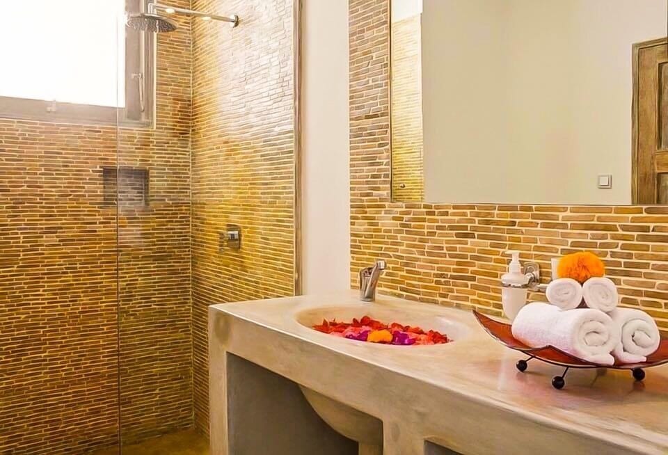 Shower, rainfall showerhead, slippers, towels
