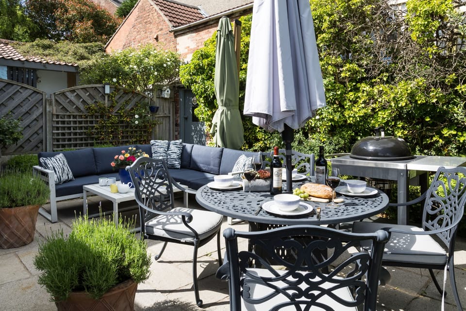 An exceptional courtyard setting, where contemporary comfort meets cottage garden charm, offering a tranquil place to unwind in style.