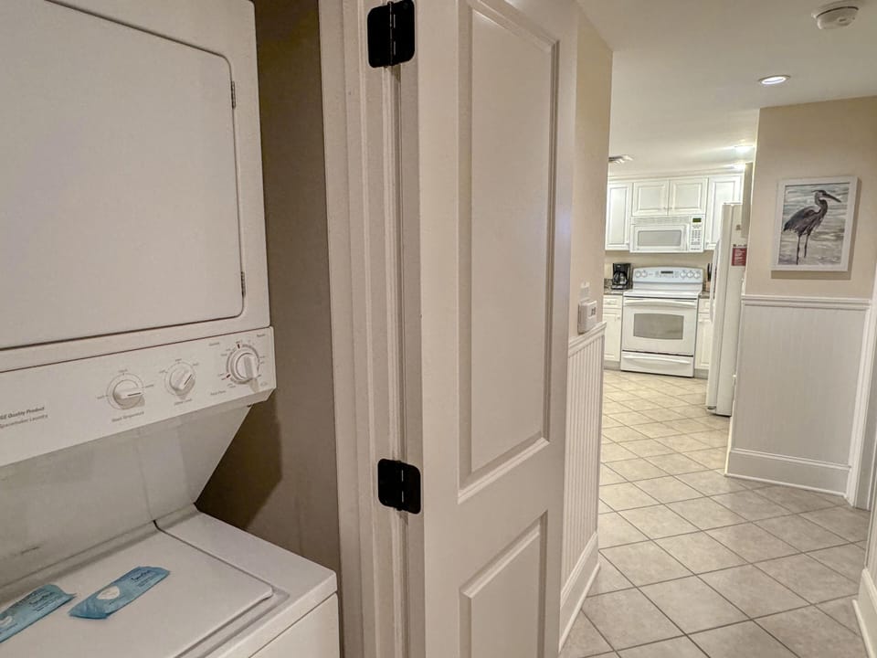 Bright laundry nook with easy kitchen access for convenience