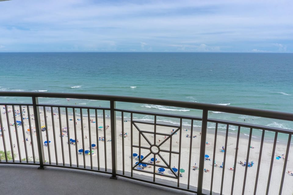 Oceanfront balcony with sweeping beach and water views