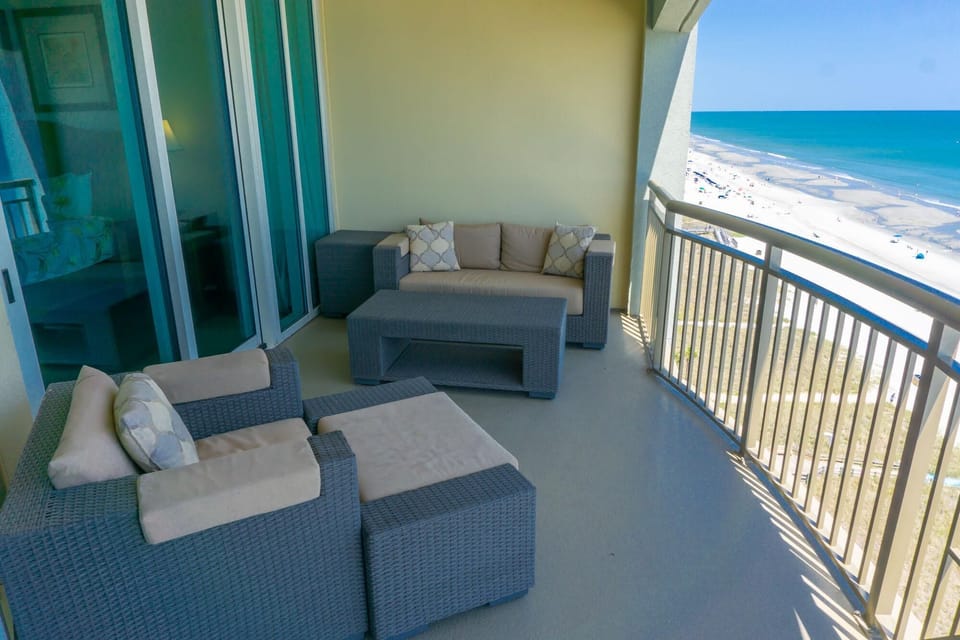 Oceanfront balcony with cozy seating and stunning views