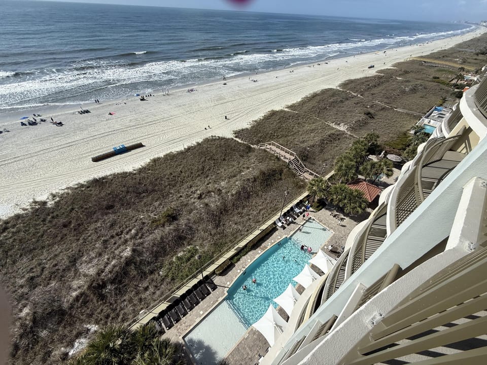 Oceanfront balcony with stunning beach and pool views