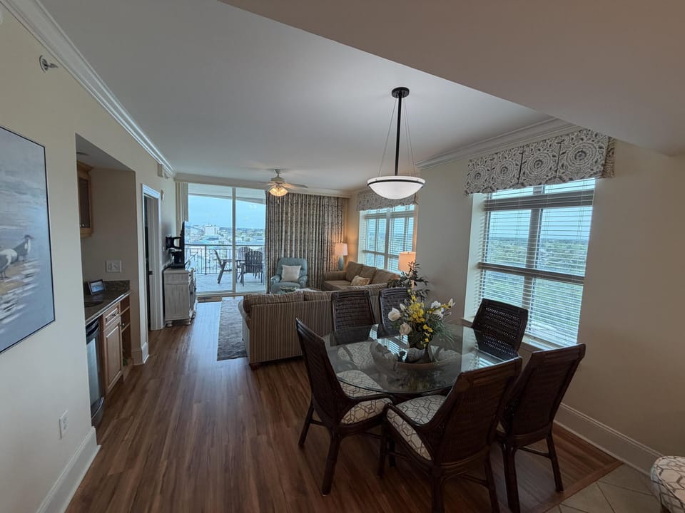 Bright open living and dining area with scenic window views