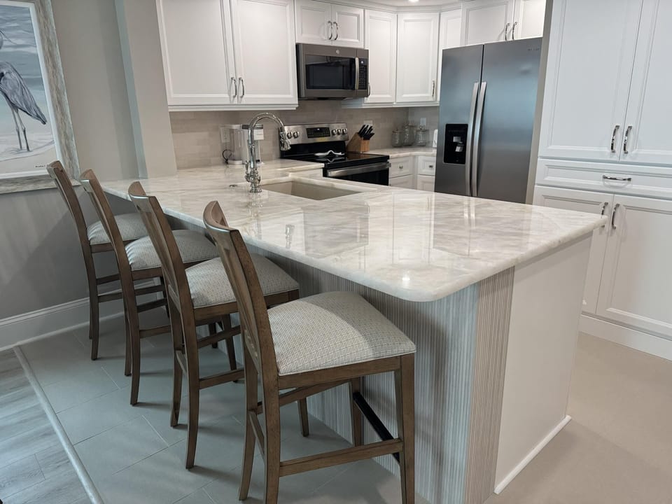Modern kitchen with sleek marble island and cozy seating
