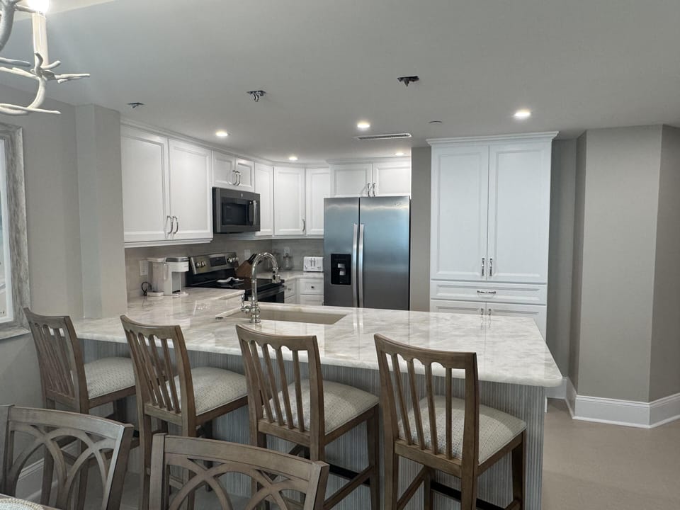 Bright, modern kitchen with spacious marble island and seating