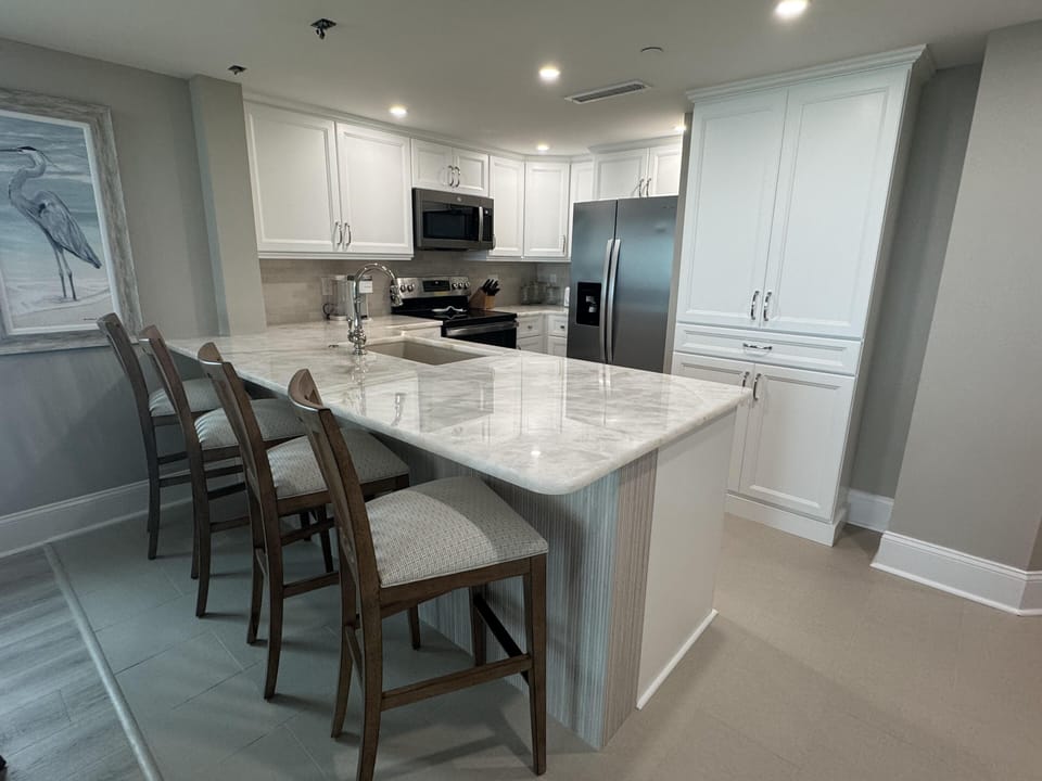 Modern kitchen with sleek countertops and cozy breakfast bar seating