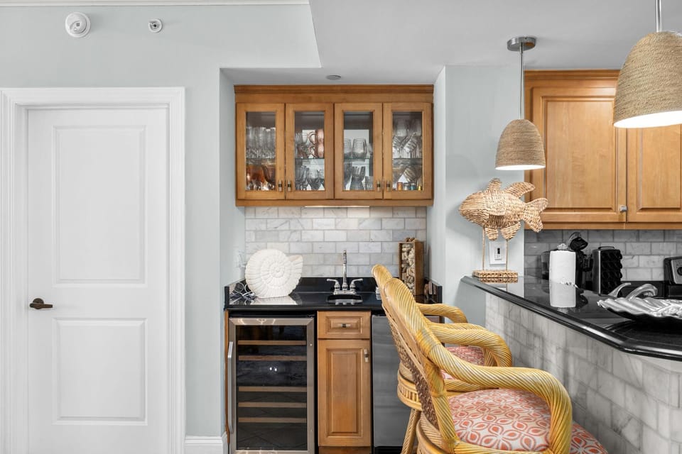 Cozy kitchen nook with stylish bar seating and wine fridge