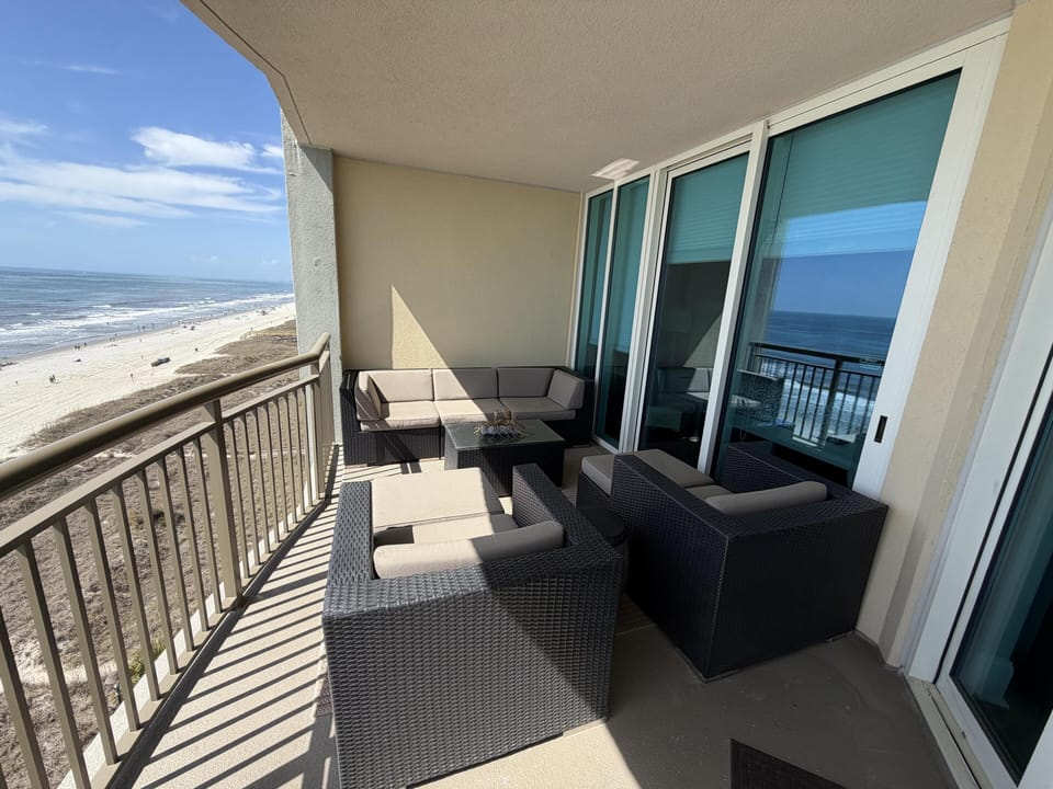 Oceanfront balcony with cozy seating and stunning views