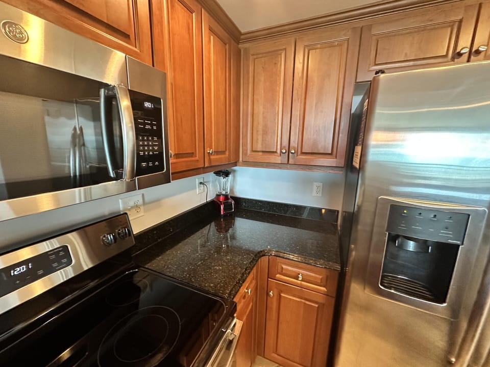 Modern kitchen with stainless steel appliances and granite countertops