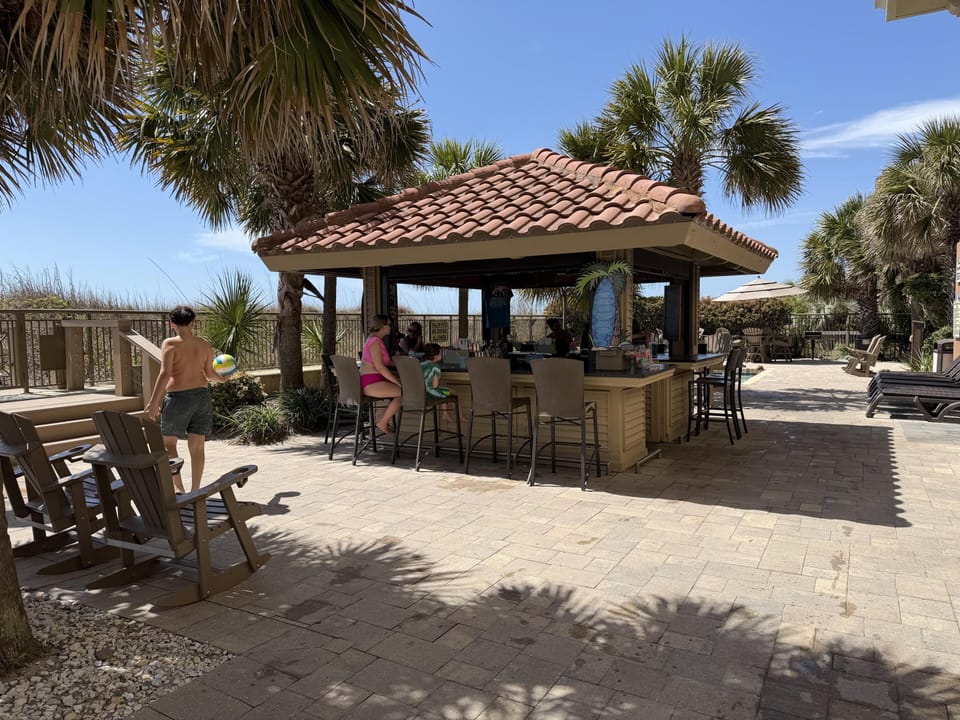 Shaded outdoor bar and lounge perfect for sunny relaxation