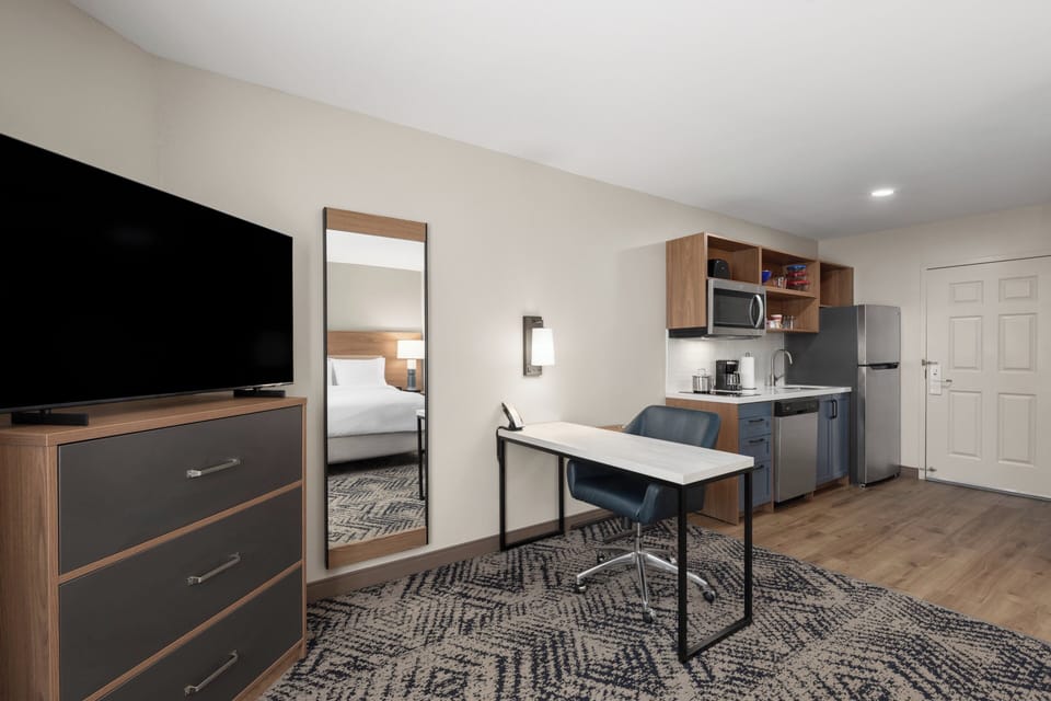 Premium bedding, desk, laptop workspace, iron/ironing board