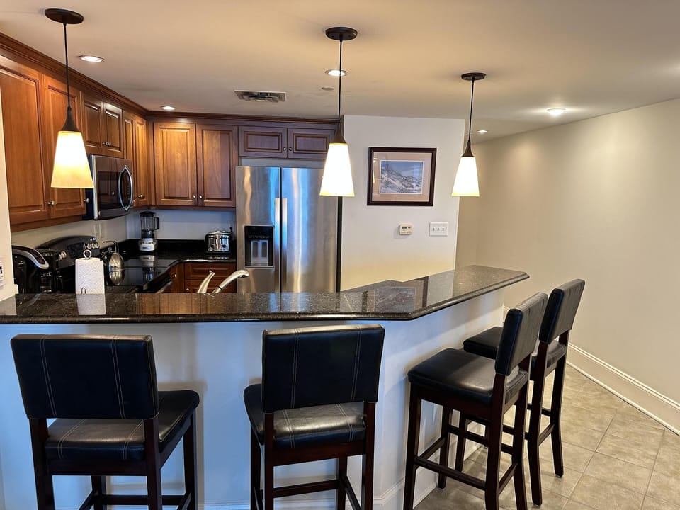 Modern kitchen with granite countertops and breakfast bar seating