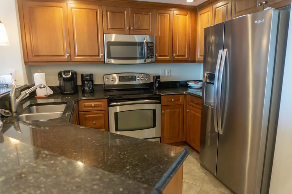 Modern kitchen with stainless steel appliances and granite countertops