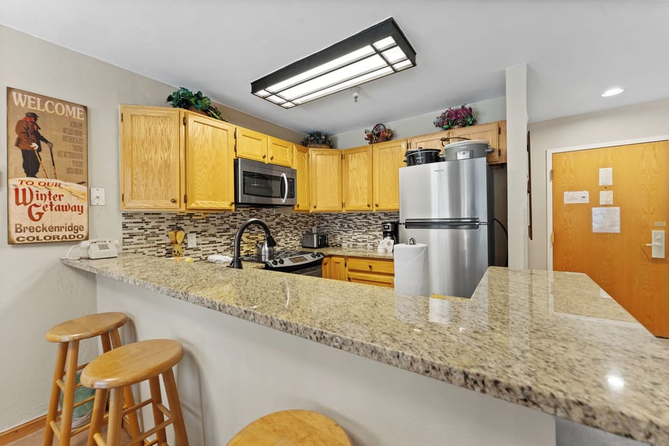Your fully equipped kitchen features granite countertops, stainless steel appliances, and everything you need to create memorable meals during your mountain getaway.