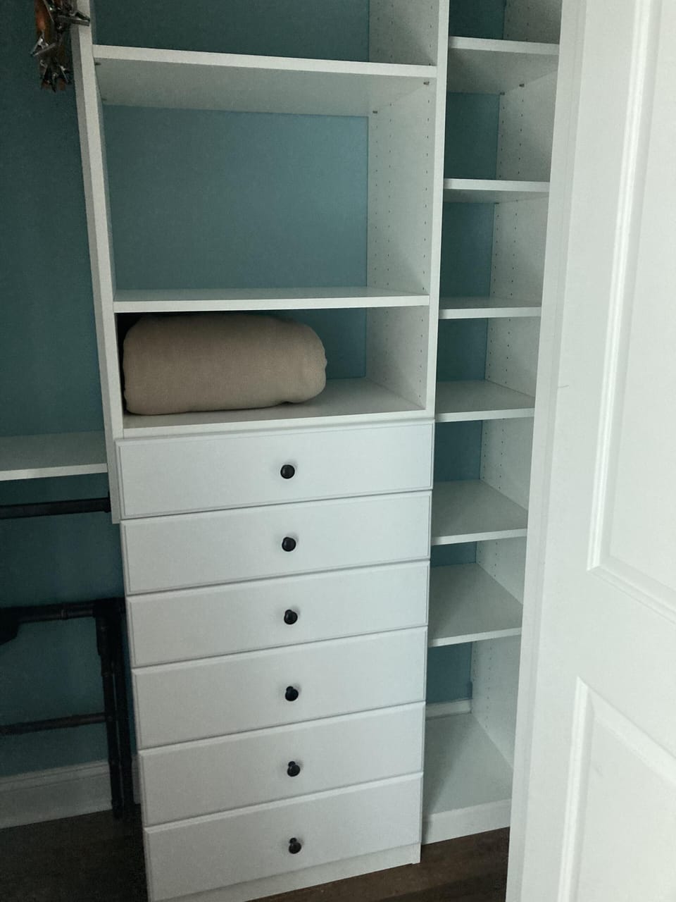 Organized walk-in closet with ample shelving and drawers