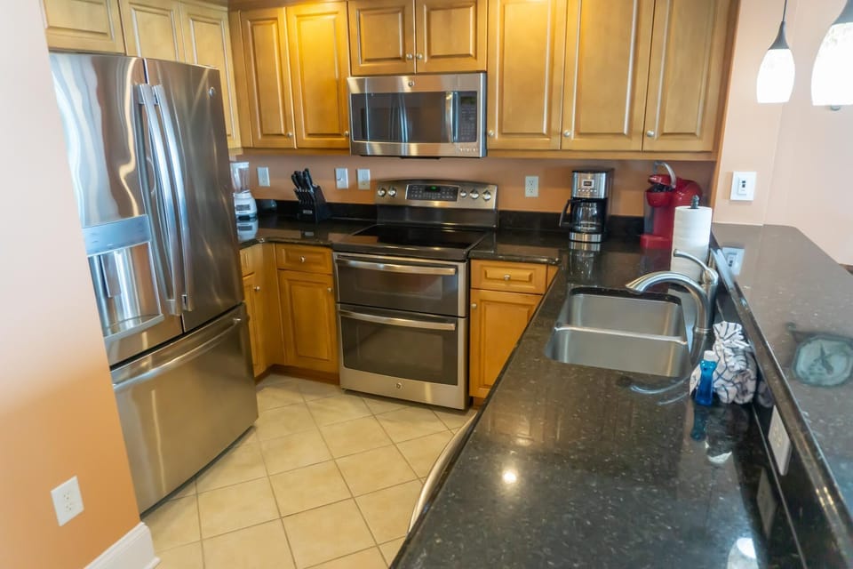 Modern kitchen with stainless steel appliances and granite countertops