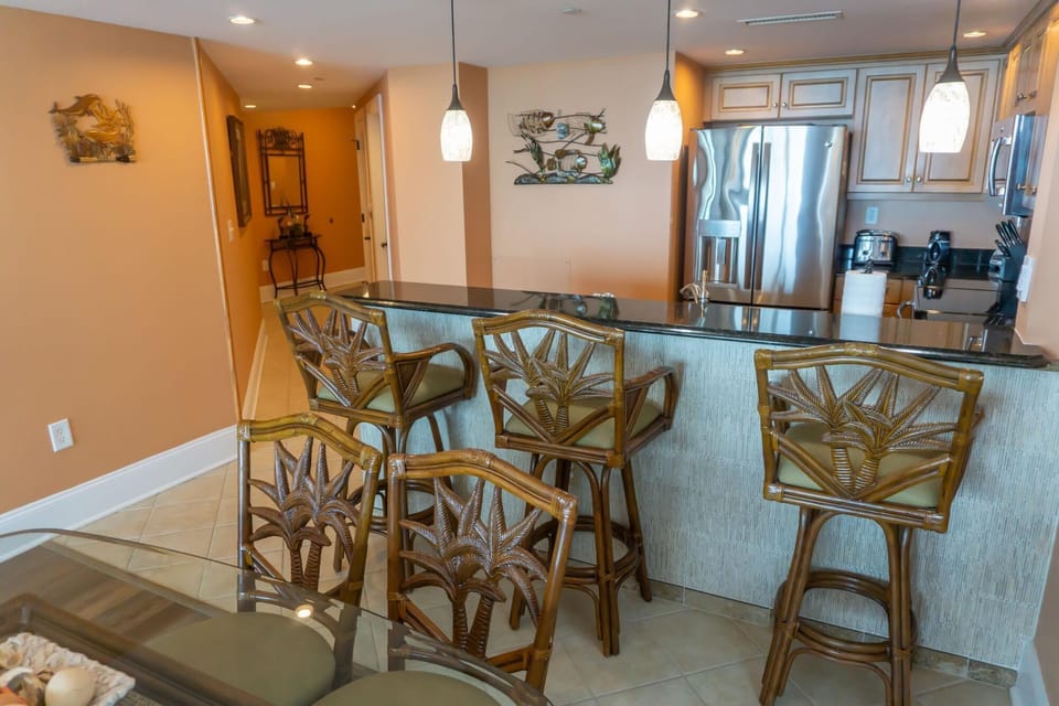 Cozy kitchen bar with tropical-inspired seating and warm lighting